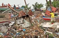 This handout photo courtesy of Angelica Villarta taken on 27 December and received on 28 December shows residents surveying damage caused by heavy rain and floods in Oroquieta City, Misamis Occidental. Photo by Handout / Angelica Villarta / AFP