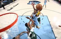 Ja Morant of the Memphis Grizzlies drives to the basket during the game against the Milwaukee Bucks. Photo by JOE MURPHY / NBAE / Getty Images / Getty Images via AFP