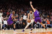 Jayson Tatum of the Boston Celtics drives the ball against Devin Booker of the Phoenix Suns during the first half of the NBA game at Footprint Center. Photo by Christian Petersen / GETTY IMAGES NORTH AMERICA / Getty Images via AFP