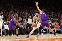Jayson Tatum of the Boston Celtics drives the ball against Devin Booker of the Phoenix Suns during the first half of the NBA game at Footprint Center. Photo by Christian Petersen / GETTY IMAGES NORTH AMERICA / Getty Images via AFP