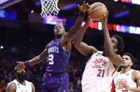 Terry Rozier of the Charlotte Hornets and Joel Embiid of the Philadelphia 76ers reach for a rebound during the fourth quarter at Wells Fargo Center. Photo by Tim Nwachukwu / GETTY IMAGES NORTH AMERICA / Getty Images via AFP