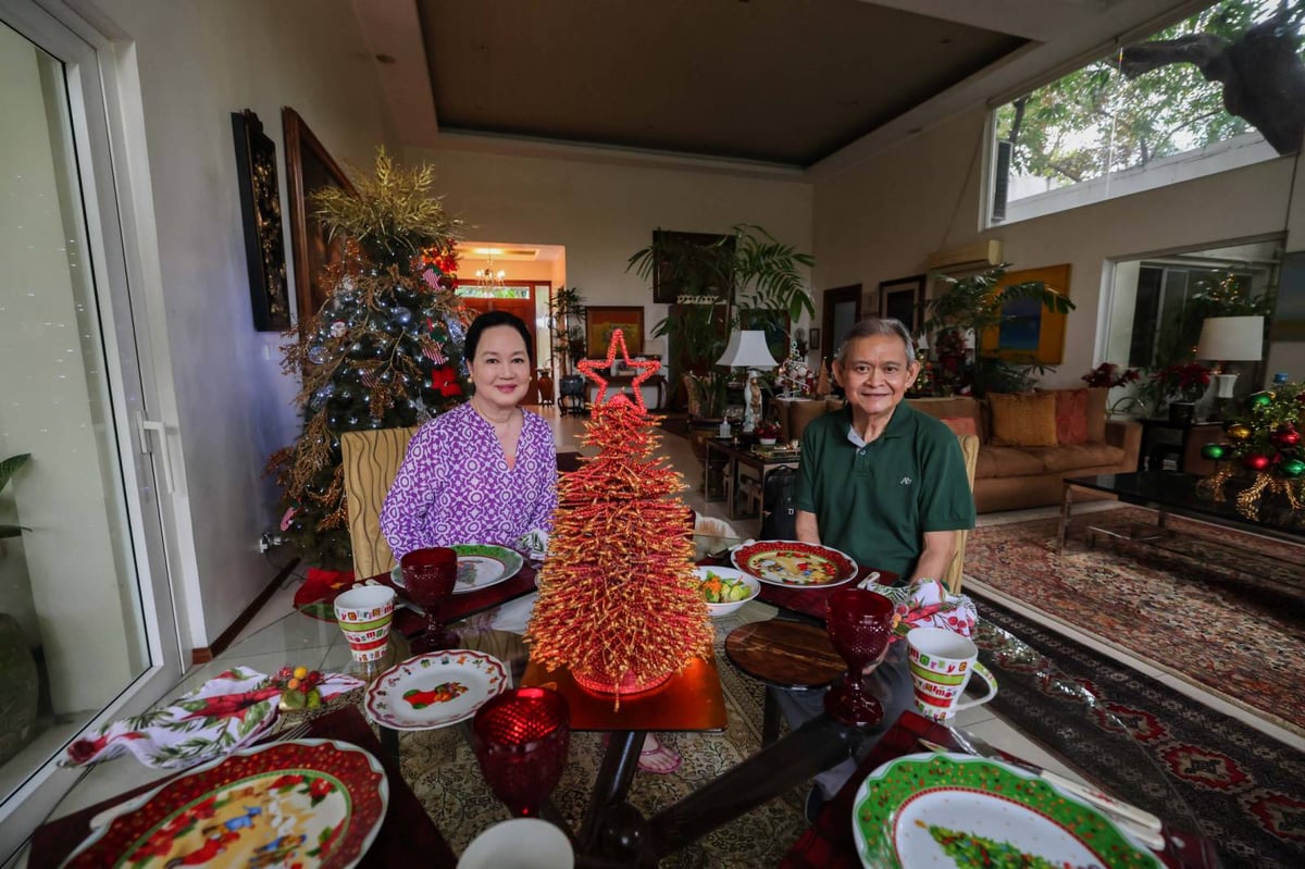 A red and gold centerpiece metal tree is a conversation piece in a corner round table. Frannie and Daily Tribune's Social Set editor Jojo G. Silvestre smile for the camera.