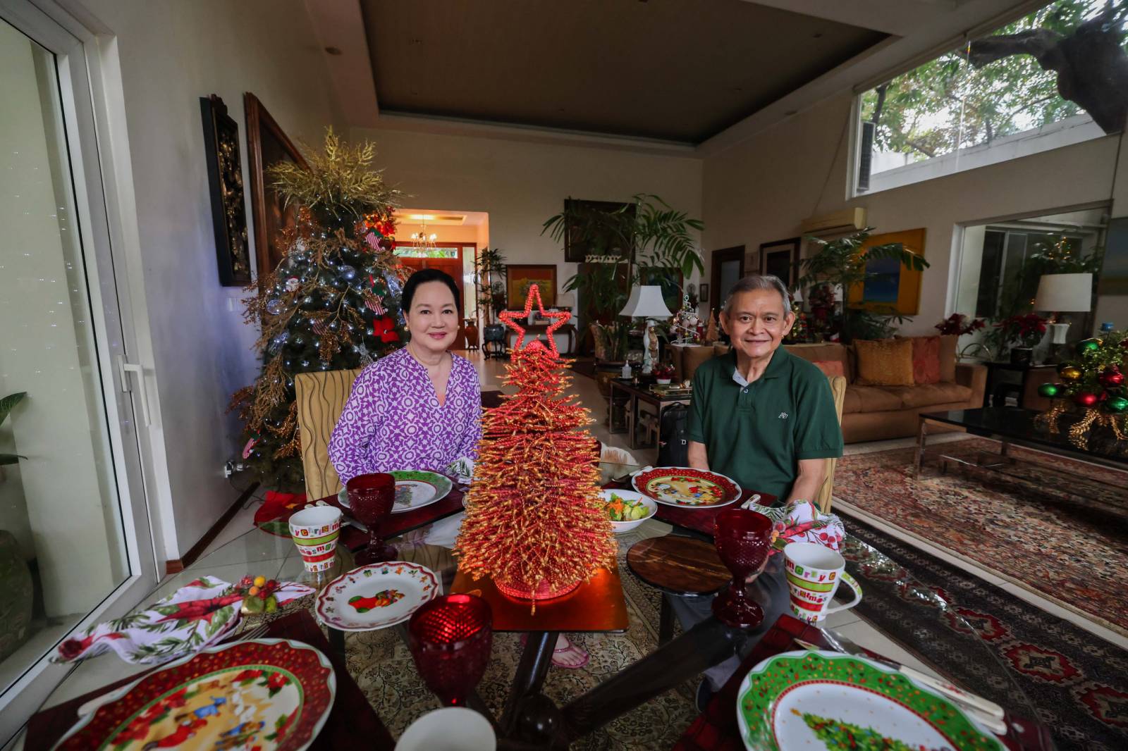 A red and gold centerpiece metal tree is a conversation piece in a corner round table. Frannie and Daily Tribune's Social Set editor Jojo G. Silvestre smile for the camera.
