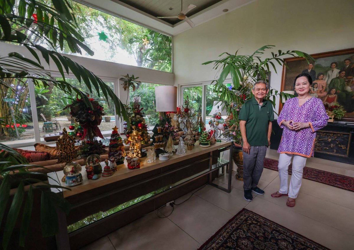 Daily Tribune Social Set editor Jojo G. Silvestre and Frannie take in the Christmas atmosphere in the Jacinto home. To their left is a buffet table full of miniature Christmas trees and baubles made of crystal, glass and semi-precious stones.