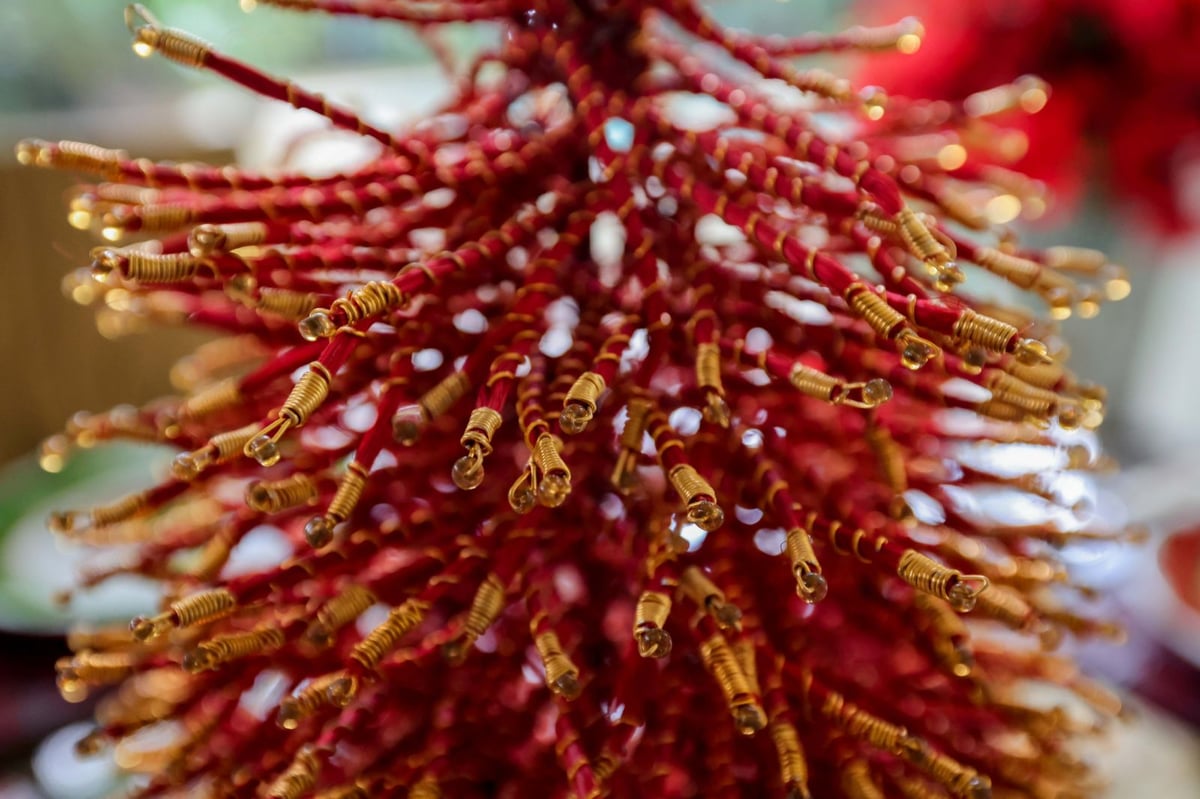 The red and gold branches of a metal Christmas tree conjure ancient oriental royal elegance