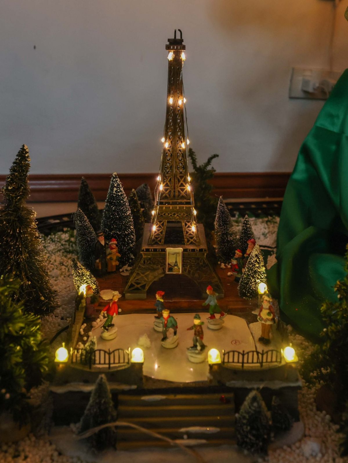 A miniature winter scene in Paris featuring the Eiffel Tower