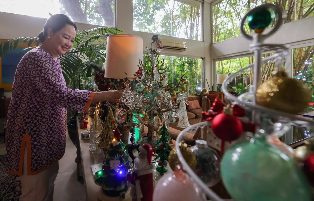 The lady of the house delights in her collection of miniature Christmas trees