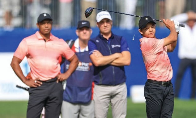 David Cannon/AGENCE FRANCE-PRESSE
CHARLIE Woods plays his tee shot on the first hole watched by his father Tiger Woods and Justin Thomas during the first round of the 2022 PNC Championship at The Ritz-Carlton Golf Club in Orlando, Florida.