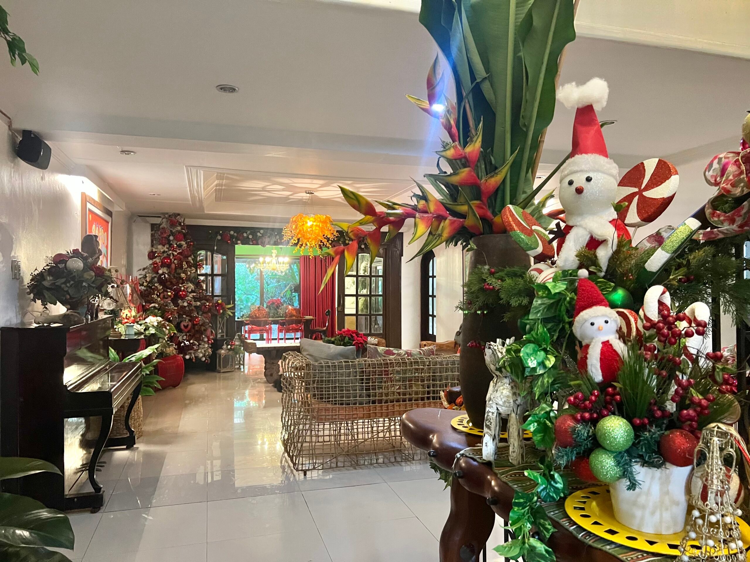 View of the living room from the entrance. Snowmen are beside the staircase.