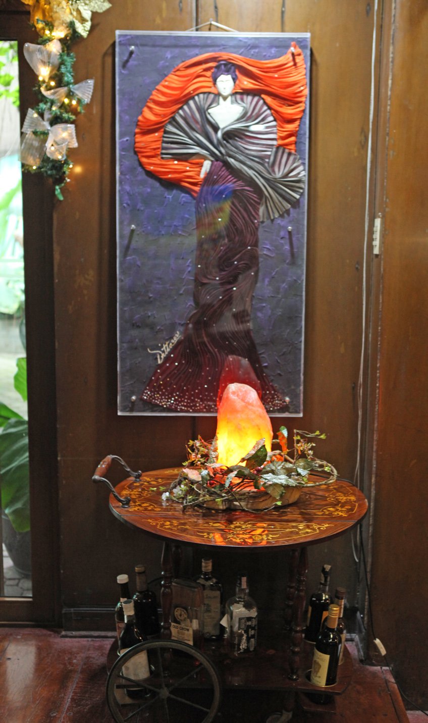 DITTA combines paint and banaca to create a beautiful woman in her olden day finery.