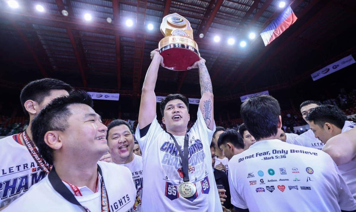 LOUIE Sangalang of Letran raises the NCAA Season 98 trophy after playing a crucial role in their title series against Saint Benilde.