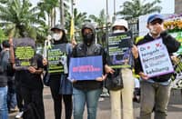 Activists protesting against Indonesia's new criminal code outside the parliament building in Jakarta on 5 December. Some of the most controversial articles in the newly passed code are criminalising premarital and extra-marital sex, as well as the cohabitation of unmarried couples. (Photo by ADEK BERRY / AFP)