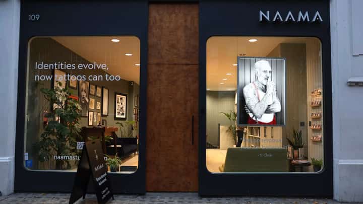 NAAMA Studios in London's upmarket Marylebone district is doing the tattoo removal for free. (Photo by ISABEL INFANTES / AFP)