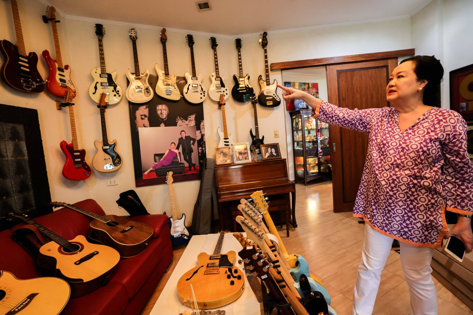 Frannie shows RJ's extensive guitar collection.