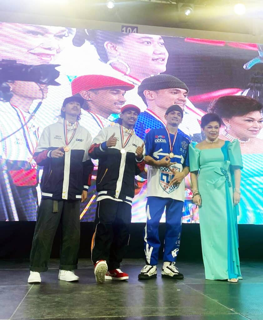 Founder and President of the Philippine DanceSport Federation Becky Garcia awards Yer Lord Ilyvm Gabriel and other team members