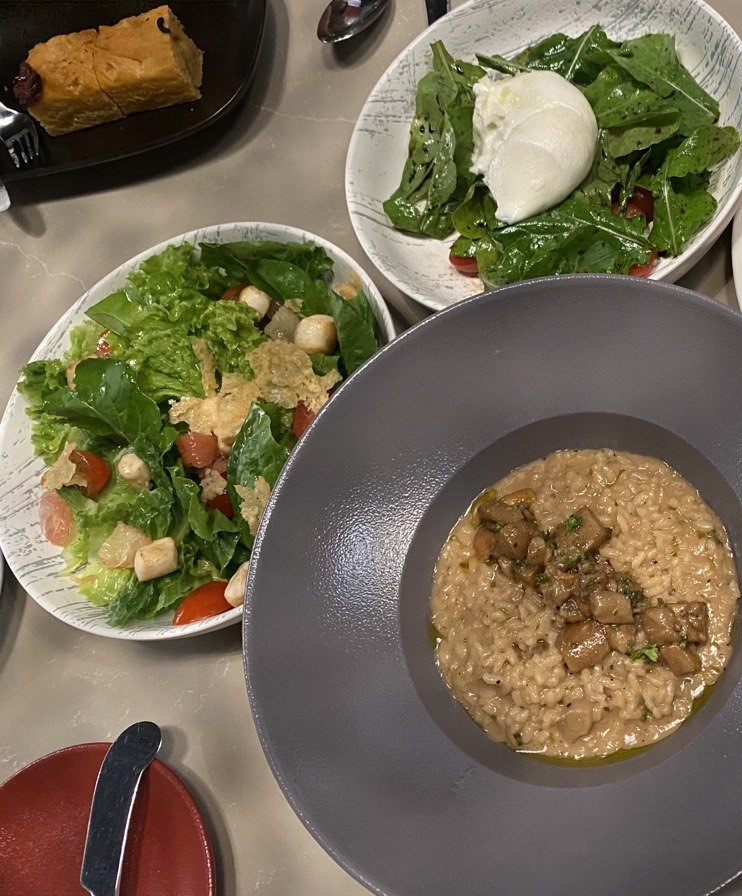 (CLOCKWISE from top) Burrata Salad, Risotto con Porcini and Il Primo Salad.