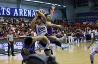 Jackson Corpuz of Magnolia gets clobbered by the defense of Kevin Racal and Jeron Teng of Converge.