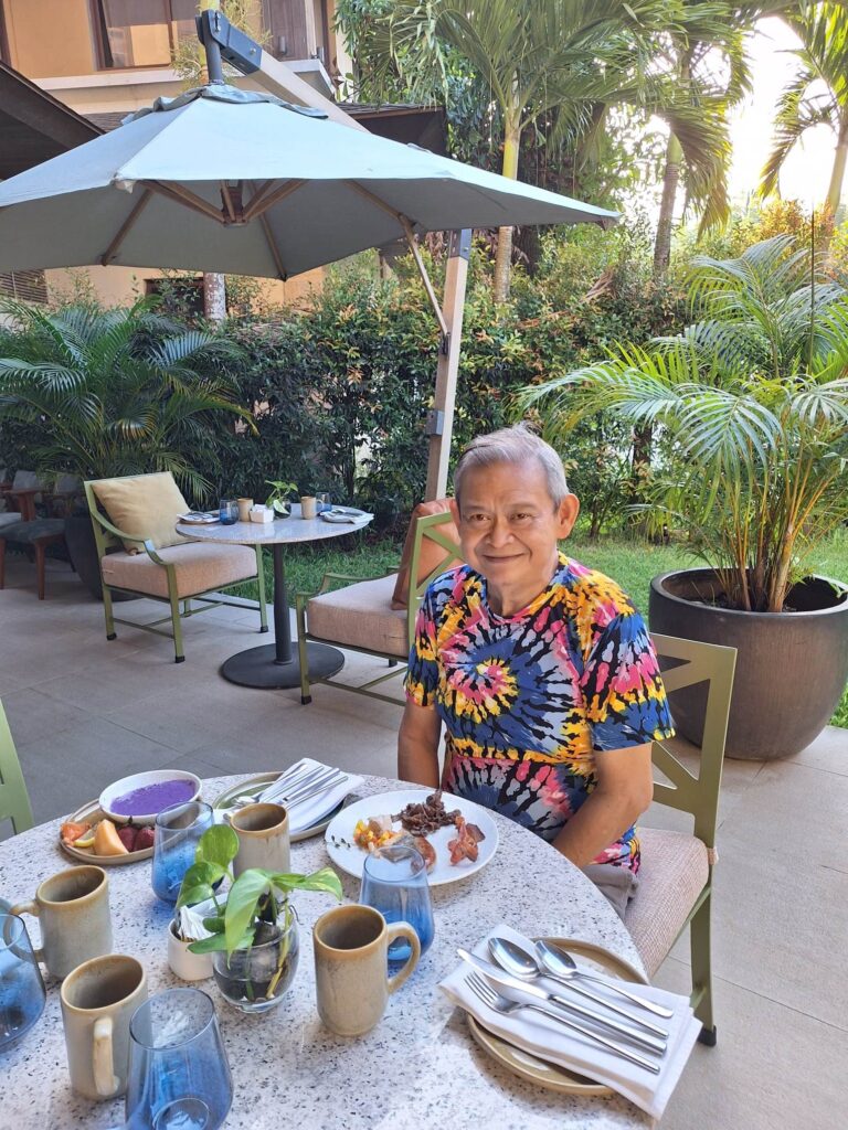 AUTHOR enjoying his breakfast by the Anya garden.