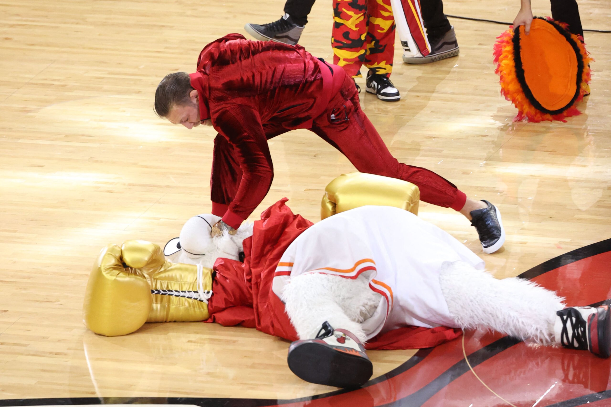 JOE MURPHY/AGENCE FRANCE-PRESSE | MMA star Conor McGregor hits Burnie, the Miami Heat mascot, during Game 4 of the NBA Finals.