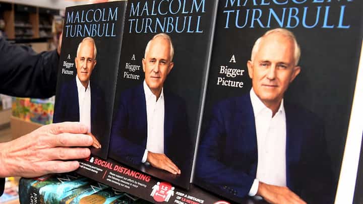 FILE PHOTO: Copies of former Australian prime minister Malcolm Turnbull autobiography are placed on the shelf after it's Australian release in Melbourne on 20 April 2020. (Photo by William WEST / AFP)