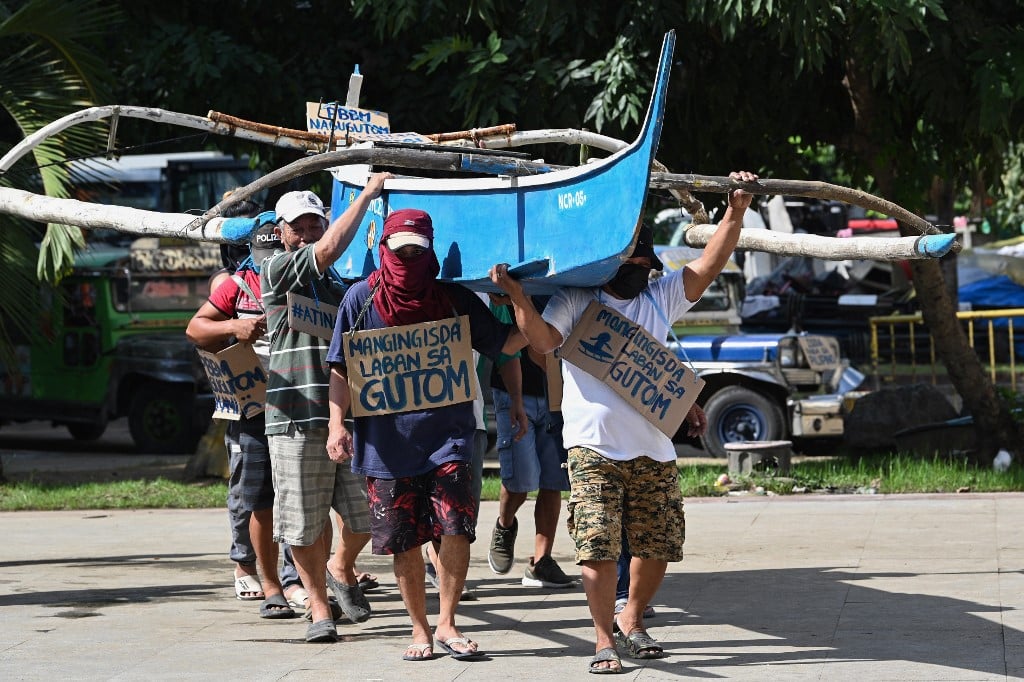 FILE PHOTO: Filipino fishermen, who say they face harassment from Chinese vessels preventing them from entering prime fishing waters in the South China Sea's Scarborough Shoal which is claimed by both countries, demonstrate at a park in Manila on 24 November 2022. (Photo by Ted ALJIBE / AFP)