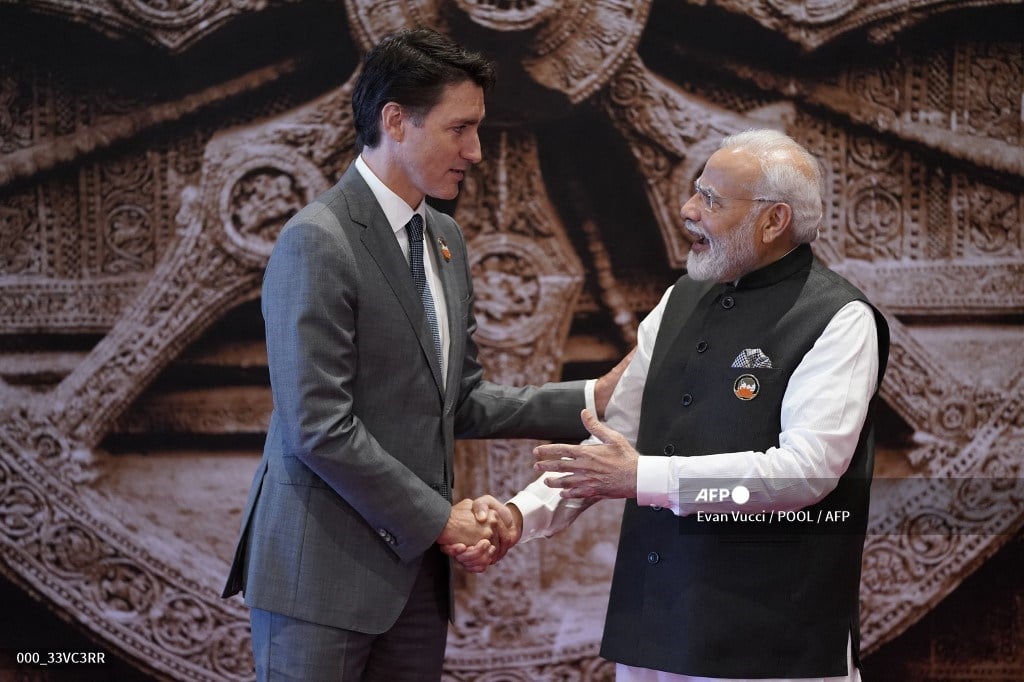India's Prime Minister Narendra Modi (R) shakes hand with Canada's Prime Minister Justin Trudeau ahead of the G20 Leaders' Summit in New Delhi on September 9, 2023. (Photo by Evan Vucci / POOL / AFP)