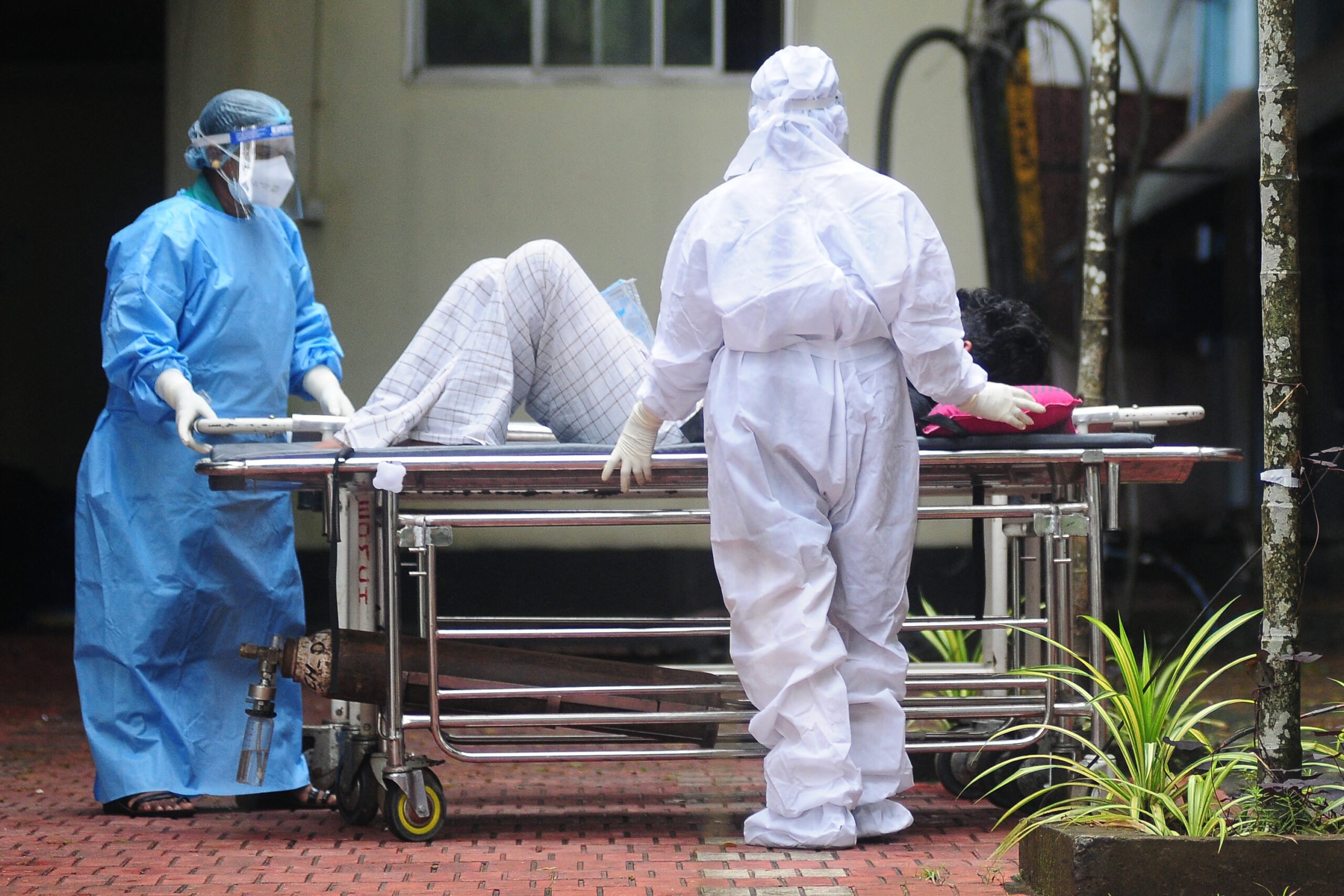 Health workers wearing protective gear shift a man with symptoms of Nipah virus to an isolation ward at a government hospital in Kozhikode in south Indian state of Kerala on 16 September 2023. (Photo by AFP)
