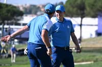 Europe's Northern Irish golfer, Rory McIlroy (L) celebrates with Europe's English golfer, Matt Fitzpatrick after sinking a putt on the 10th green during his four-ball match on the first day of play in the 44th Ryder Cup at the Marco Simone Golf and Country Club in Rome on September 29, 2023. (Photo by Paul ELLIS / AFP)