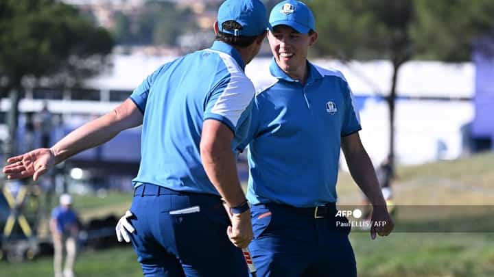 Europe's Northern Irish golfer, Rory McIlroy (L) celebrates with Europe's English golfer, Matt Fitzpatrick after sinking a putt on the 10th green during his four-ball match on the first day of play in the 44th Ryder Cup at the Marco Simone Golf and Country Club in Rome on September 29, 2023. (Photo by Paul ELLIS / AFP)