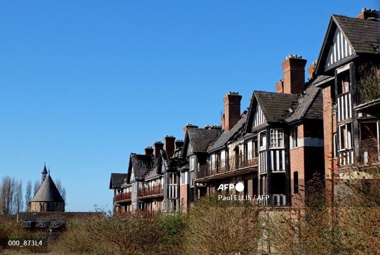 FILE PHOTO: The derelict tenement blocks of Eldon Grove are pictured in the winter sunshine in Liverpool, north west England on 23 February 2016. The three blocks, were the first council flats in the UK to be built outside of London, in 1912, and were given Grade II listed status in 1993. After more than a decade of being left in disrepair there are plans to re-develop the blocks back into residential use. (Photo by Paul ELLIS / AFP)