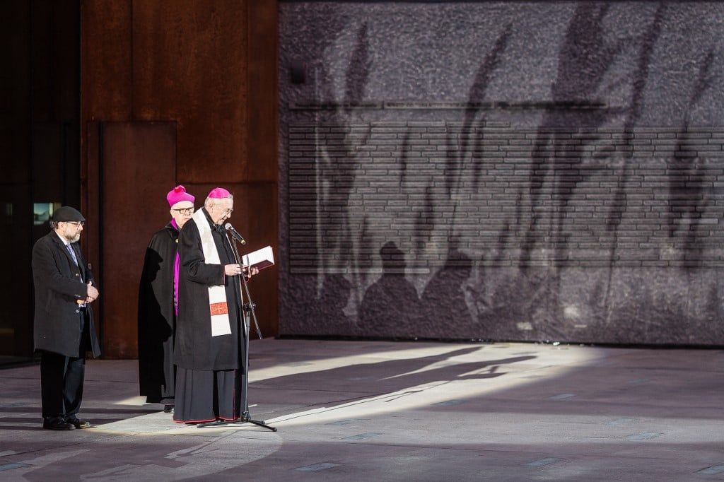 Archbishop Stanislaw Gadecki (R), the head of Episcopate of Poland, says prayer as archbishop Jozef Michalik and Polish chief rabi Michael Schudrich (L) during opening ceremony of The Ulma Family Museum Of Poles Saving Jews in World War II. The Ulma family sacrifice their lives as they were hiding Jews during Holocaust and WWII. (Photo by WOJTEK RADWANSKI / AFP)