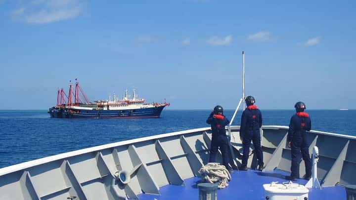 Philippine Coast Guard crew members aboard the BRP Cabra monitor a Chinese vessel anchored at Sabina Shoal, a West Philippine Sea outcrop located about 135 kilometers west of Palawan. China’s ‘aggressive’ actions in the WPS has earned condemnation from the Philippines and such countries as the United States, Japan and Australia. (Handout/Philippine Coastguard/AGENCE FRANCE-PRESSE)