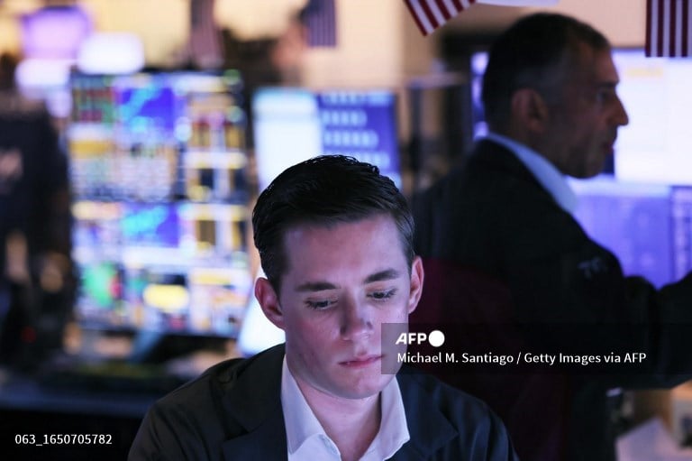 US stocks slip as traders assess signs of slowing economy