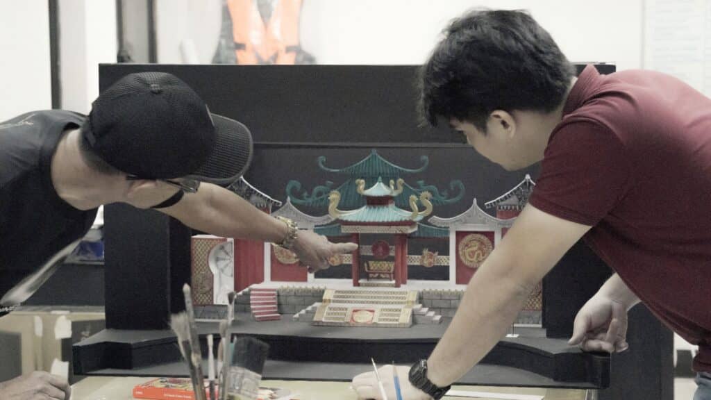 Amado Bonifacio III prepares a production's scale model with his mentor Manong Junior.