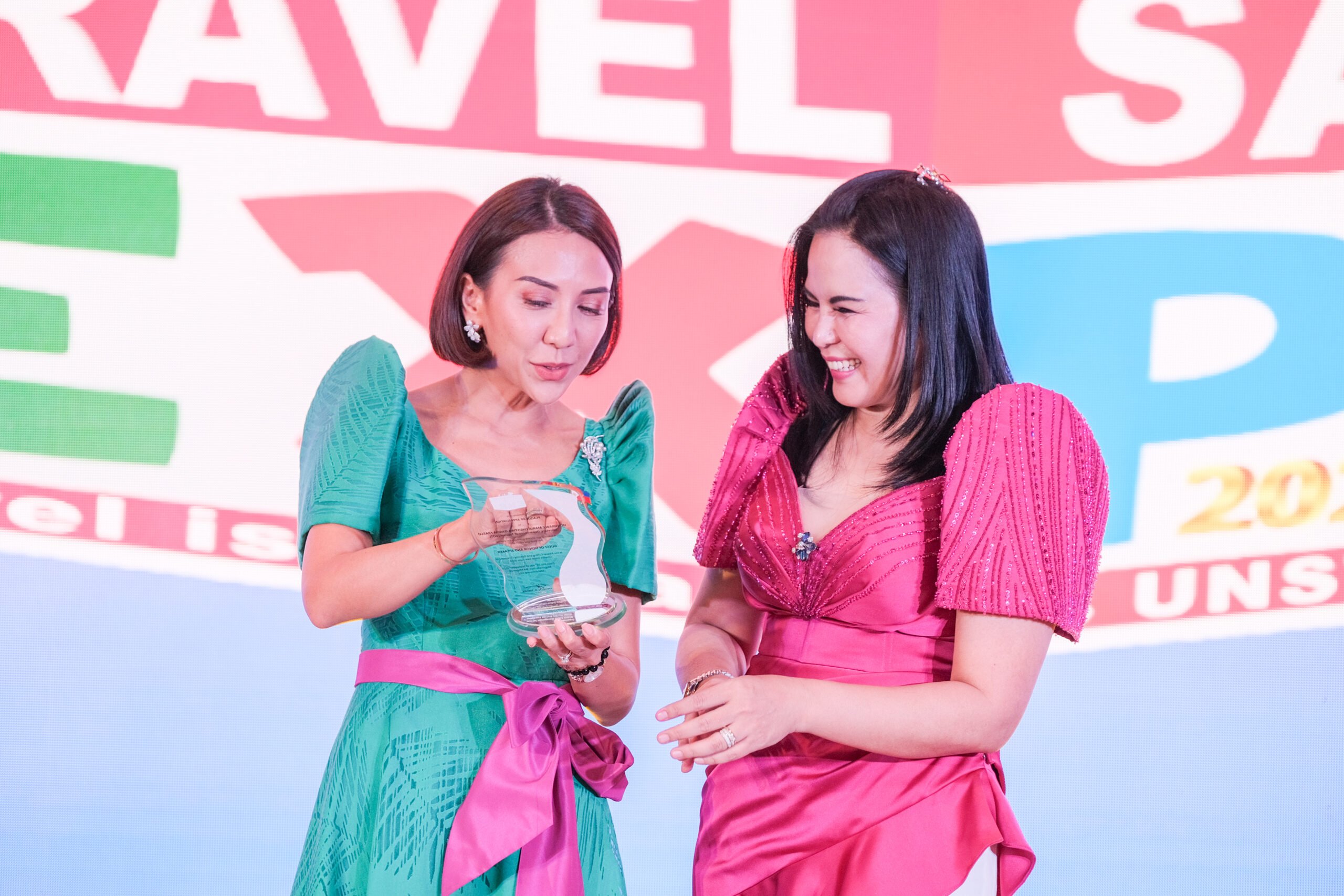 Tourism Secretary Cristina Garcia Frasco (left) joyfully accepts the plaque of appreciation from Philippine Travel Agencies Association president Michelle Taylan for gracing the Travel Sale Expo 2023 held at SM Megamall Megatrade Hall on Friday. | Photograph by King Rodriguez for the Daily Tribune