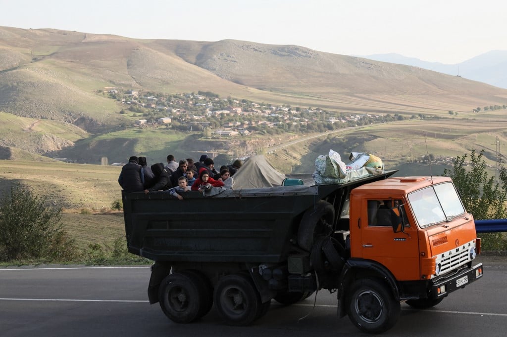 A truck with refugees on board rides on the road between Kornidzor and Goris on 28 September 2023. Armenia said 28,120 refugees have so far arrived from Nagorno-Karabakh, a majority ethnic Armenian breakaway enclave defeated in a lightning offensive by Azerbaijan last week. (Photo: ALAIN JOCARD / AFP)