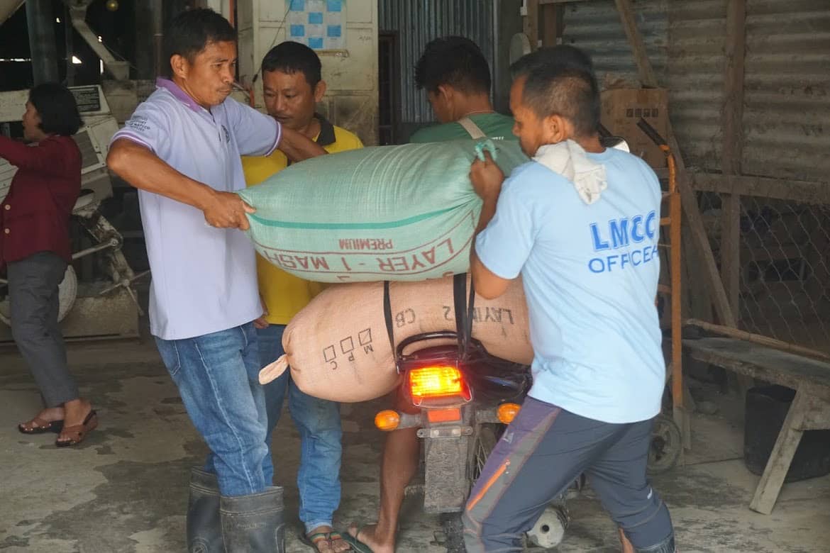 Members of the Laak Multipurpose Cooperative in Laak, Davao de Oro prepare to mill rice grains or palay following the electrification assistance of the One Meralco Foundation.