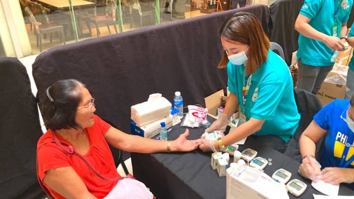 An elderly patient gets her blood tested for free at Watsons Philippines' medical mission in SM City Davao.