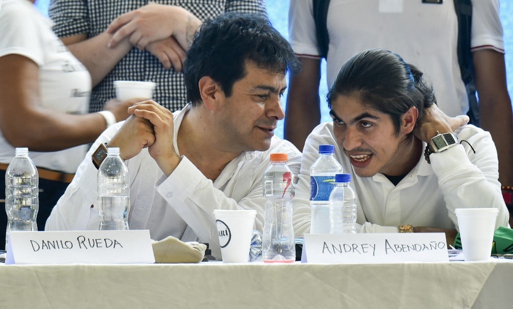 Alias Andrey Avendaño (R), the spokesman and chief negotiator of the so-called Central General Staff (EMC) -- a dissident faction of the Revolutionary Armed Forces of Colombia (FARC)-- speaks with Danilo Rueda (L) during the installation of official peace negotiations with the Colombian Government, in the municipality of Tibu, Norte de Santander Department, Colombia, on 8 October 2023. The Colombian government and the main group of FARC guerrilla dissidents who did not sign a peace deal in 2016, set up a negotiating table on Sunday seeking to demobilize some 3,500 rebels and putting a definitive end to their armed insurgency. (Photo by Schneyder Mendoza / AFP)