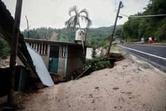 Picture of a house on land which gave way at the Kilometro 42 community, near Acapulco, Guerrero State, Mexico, after the passage of Hurricane Otis, on 25 October 2023. Mexican authorities rushed to send emergency aid, restore communications and assess damage in the Pacific beach resort of Acapulco on Wednesday after a powerful hurricane left a trail of destruction and tourists stranded. (Photo by RODRIGO OROPEZA / AFP)