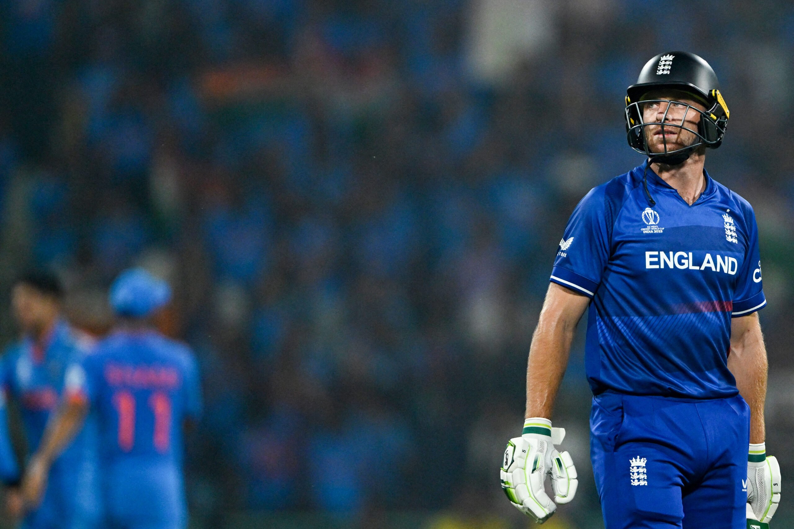 England's captain Jos Buttler walks back to the pavilion after his dismissal during the 2023 ICC Men's Cricket World Cup one-day international match between India and England at the Ekana Cricket Stadium in Lucknow on 29 October 2023. (Photo by TAUSEEF MUSTAFA / AFP)