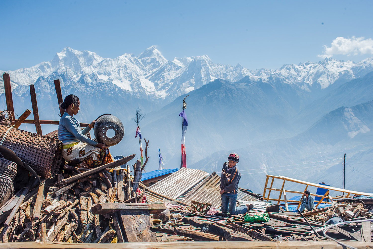 FILE: A woman from Singla village extracts her belongings from the rubble. 1 October 2023.