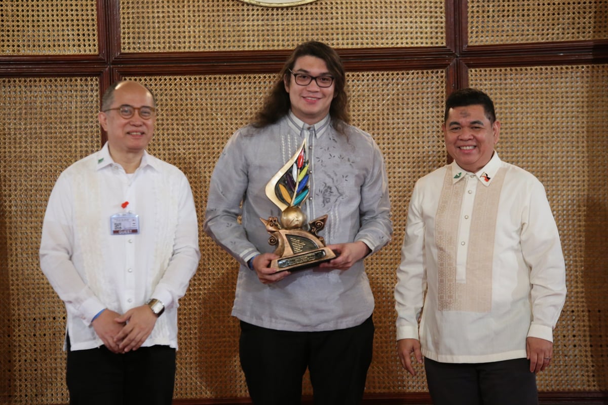Cristobal (center) receives the Ani Ng Dangal Award with NCCA officials