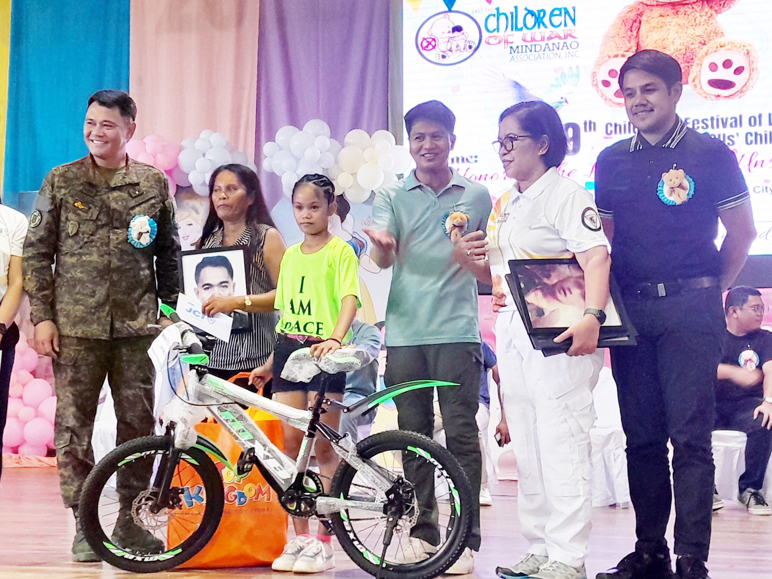 Photograph by Nonoy Lacson for the daily tribune
Members of the Save the Children of War Mindanao Association Incorporated provide bicycles to children of CAFGU members at the Lamitan City Gym last Saturday.