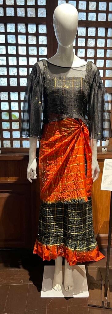 A Balintawak-inspired ensembe composed for the camisa, tapos and sash over a sleeveless dress.