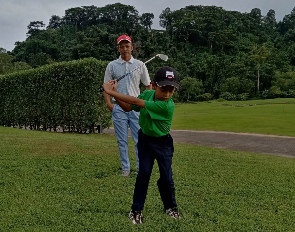 A TYPICAL bonding time between Rico Opinion and son Ezekiel means a hands-on golf training.
