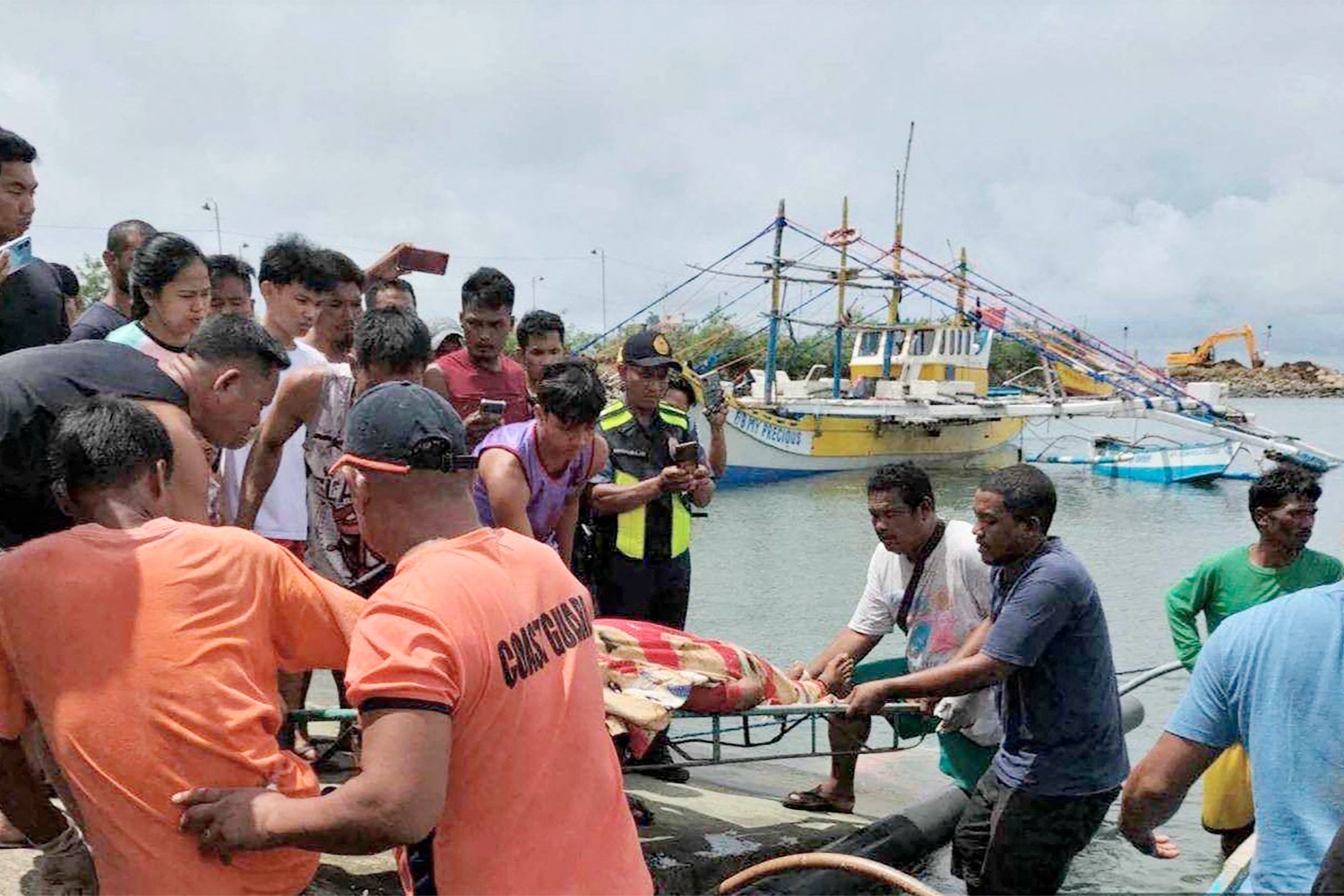 PCG/AGENCE FRANCE-PRESSE 
Tragic collision at WPS Coast Guard personnel retrieve remains of one of three Filipino fishermen killed after their boat was fatally rammed on Monday by a foreign oil tanker off Bajo de Masinloc, Zambales.