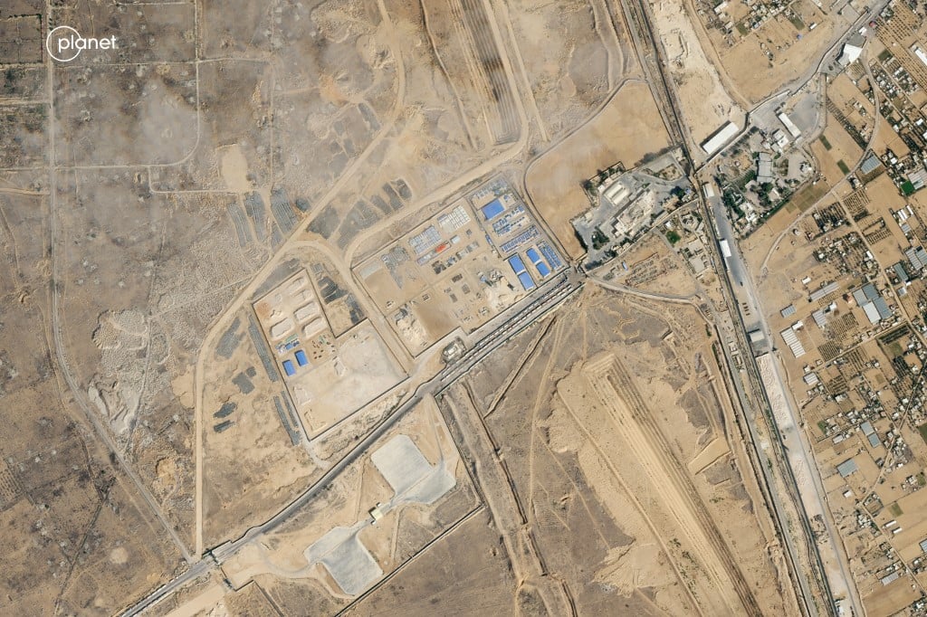 (FILE) THIS handout satellite picture released by Planet Labs PBC shows the Rafah crossing between the Gaza Strip and Egypt with a queue of trucks carrying aid waiting at the border