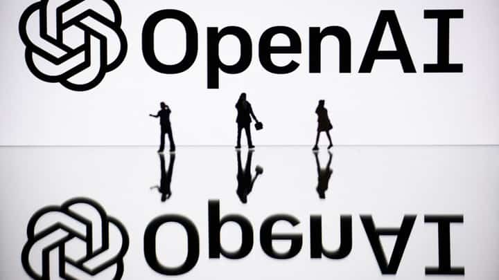 FILE PHOTO: This illustration photograph taken on 30 October 2023, in Mulhouse, eastern France, shows figurines next to a screen displaying a logo of OpenAI, a US artificial intelligence organization. (Photo by SEBASTIEN BOZON / AFP)