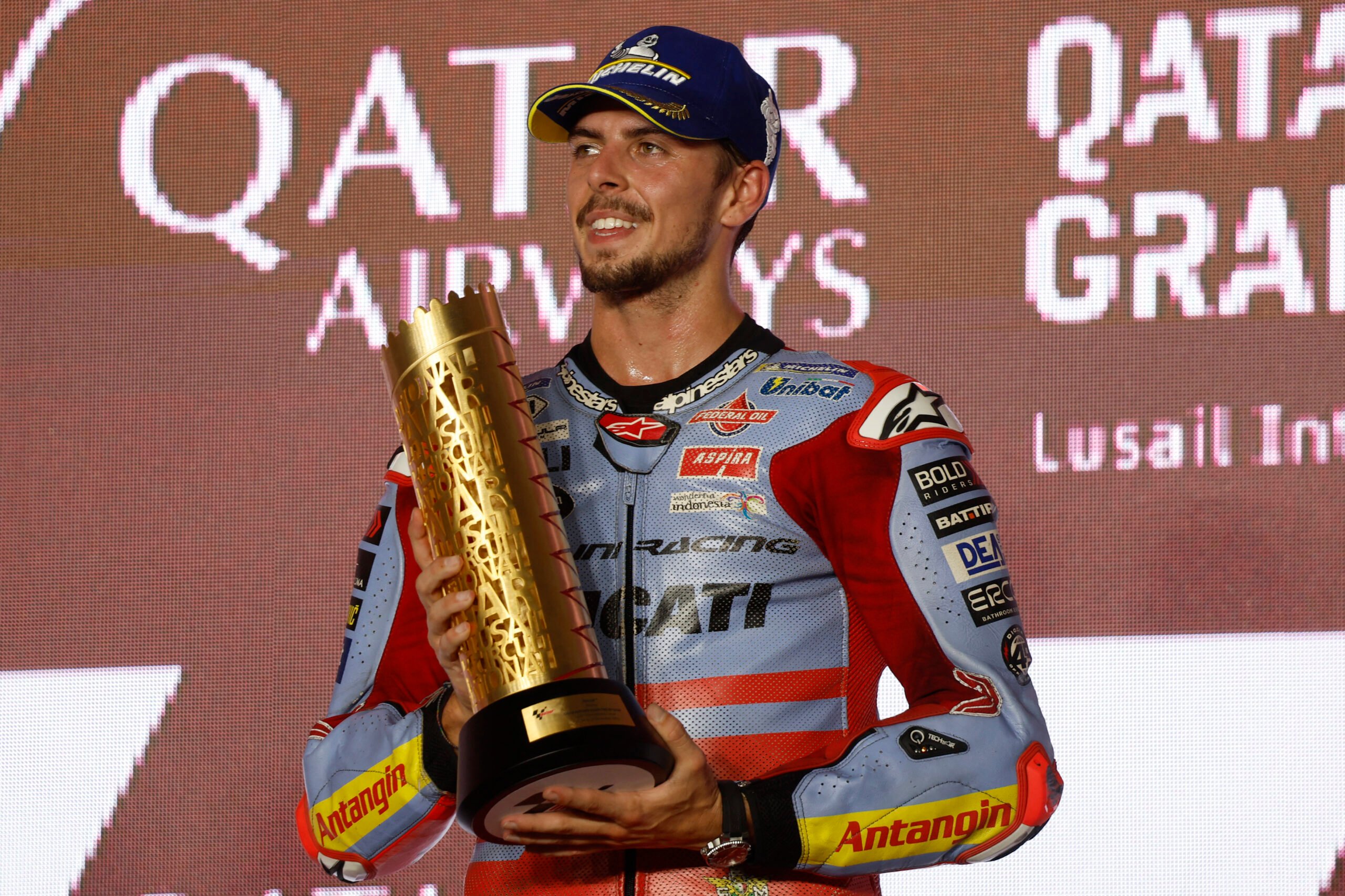 Gresini Racing's Italian rider Fabio Di Giannantonio celebrates on the podium after winning the Moto GP Grand Prix of Qatar at the Lusail International Circuit, in the city of Lusail on 19 November 2023. (Photo by KARIM JAAFAR / AFP)